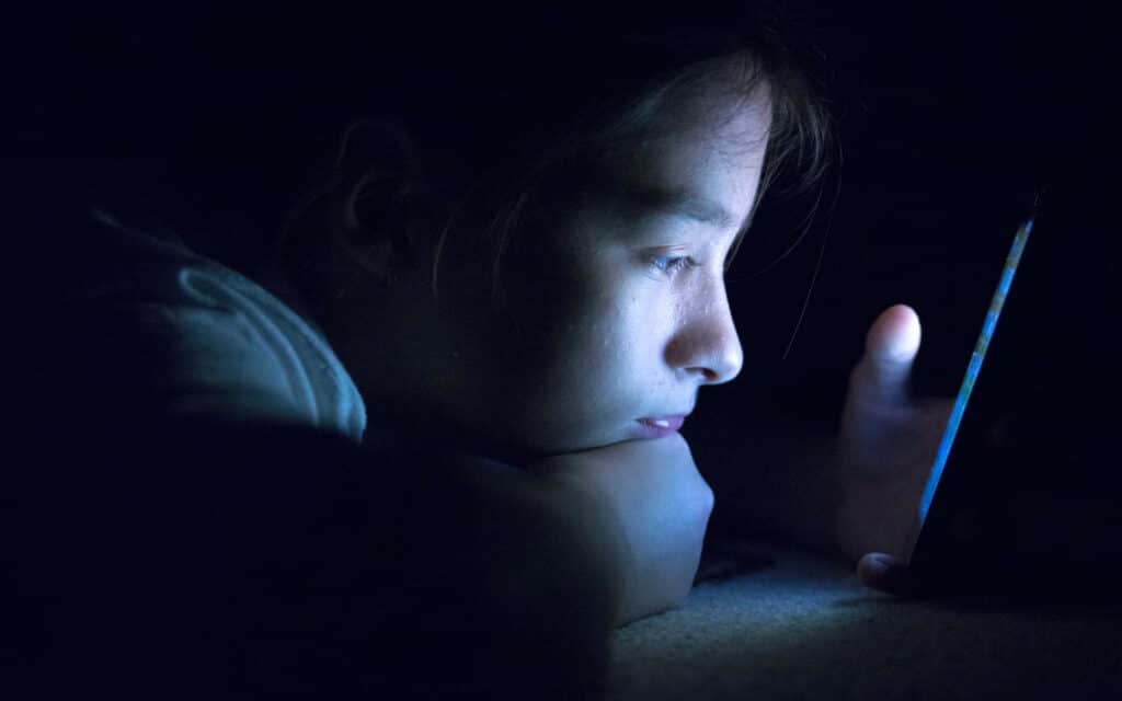 Image of a young oerson looking at her phone