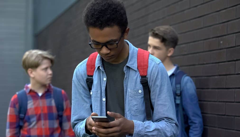 Image of a student looking at his phone