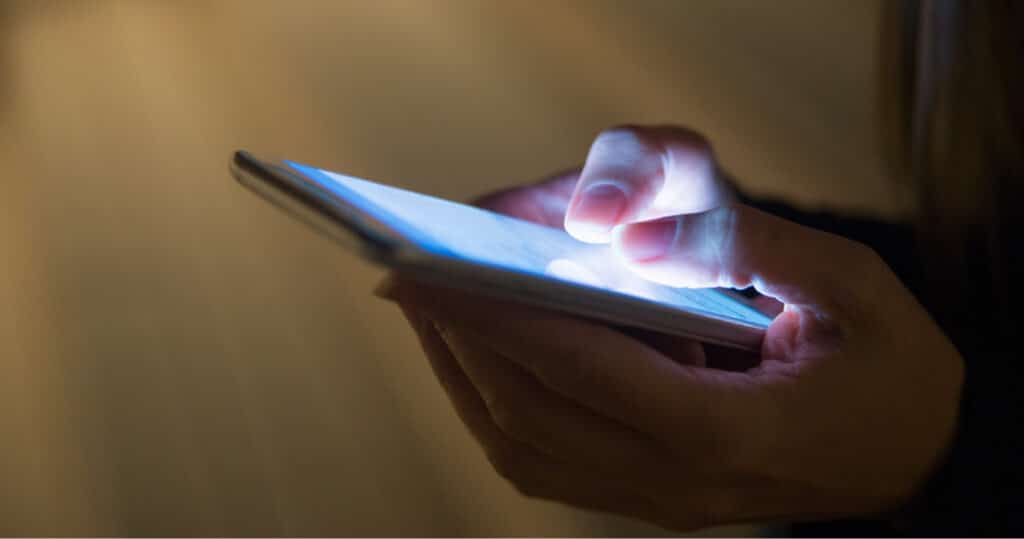 Image of a young person on their phone